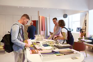 Group of NeoCon attendees viewing material swatches (Photo Courtesy of NeoCon)